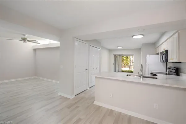 a view of kitchen with window and wooden floor
