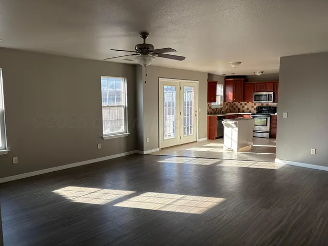 a view of a kitchen with wooden floor a sink and a window