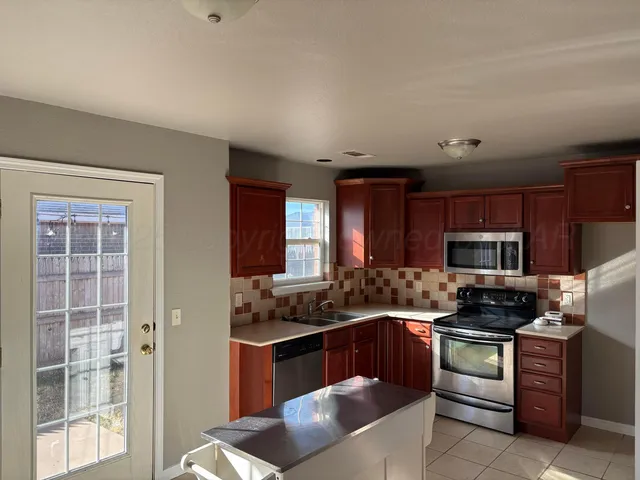 a kitchen with a stove a sink and a microwave