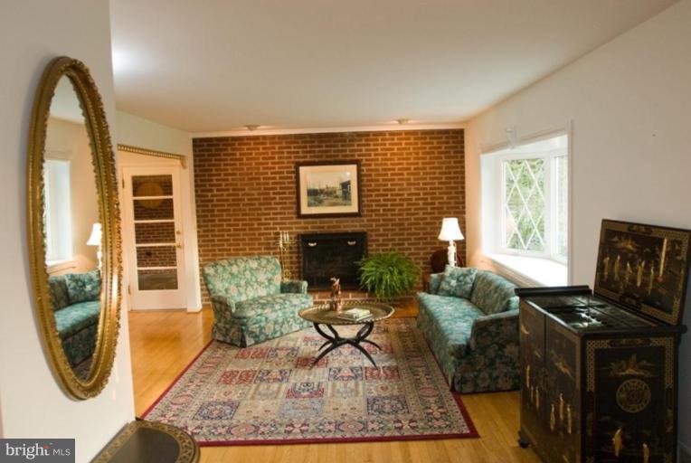 5618 Allender Road White Marsh, MD 21162 - Photo 7 of 19 a living room with furniture a rug and a floor to ceiling window