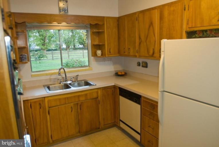 5618 Allender Road White Marsh, MD 21162 - Photo 10 of 19 a kitchen with a sink a stove and a refrigerator