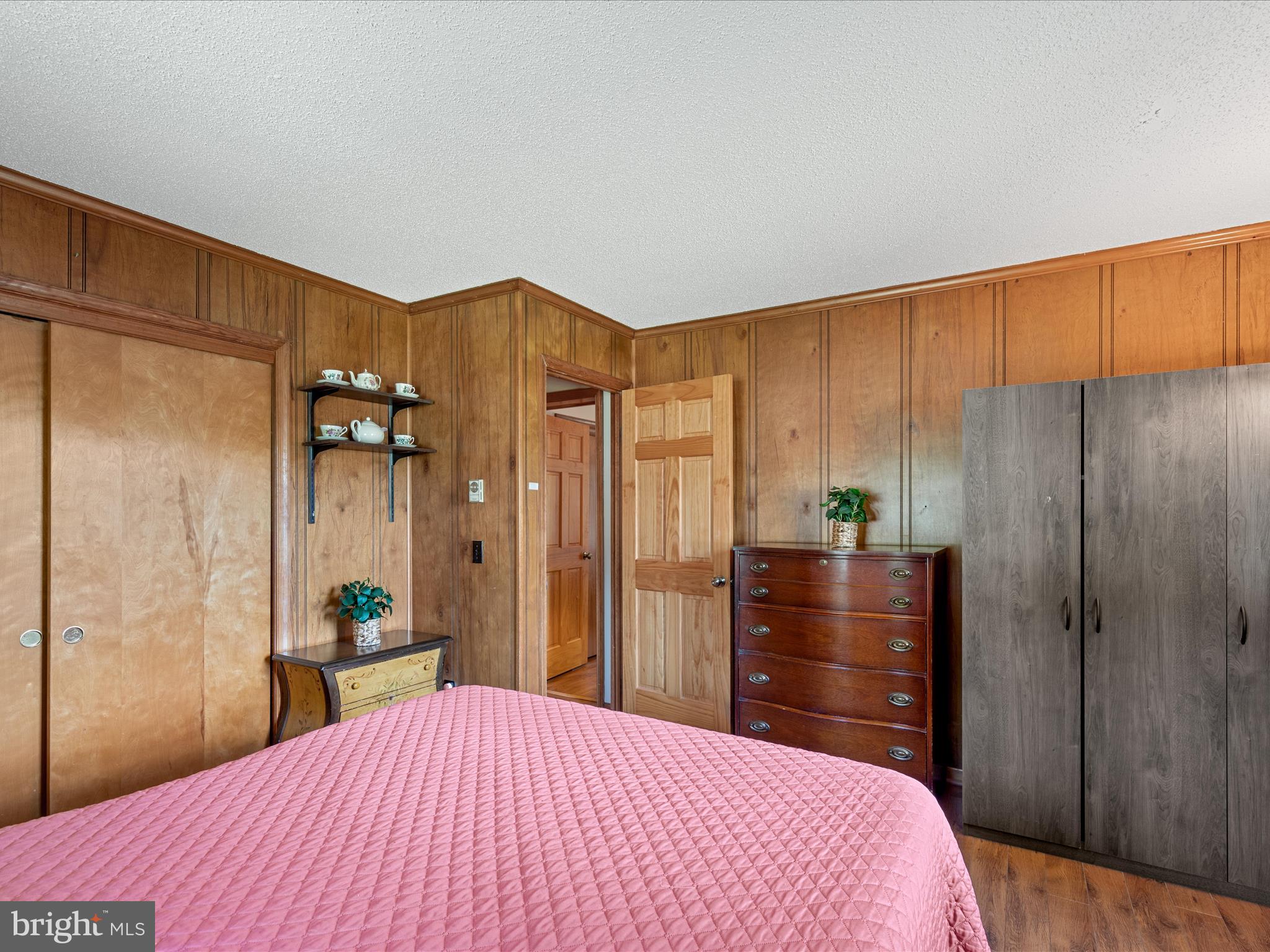 23488 Deal Island Road Deal Island, MD 21821 - Photo 22 of 52 a bedroom with a bed and a dresser