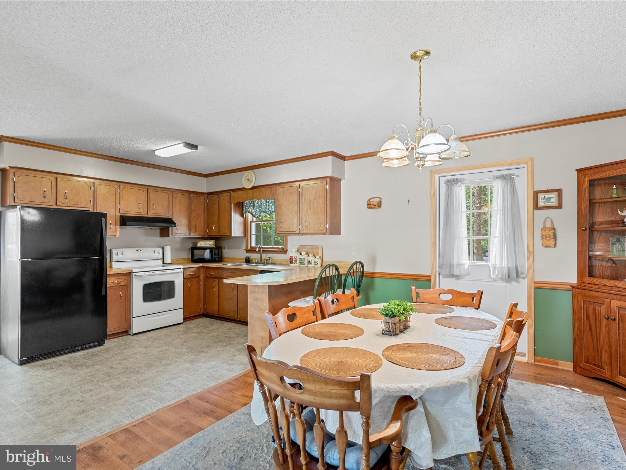23488 Deal Island Road Deal Island, MD 21821 - Photo 9 of 52 a large kitchen with a table and chairs