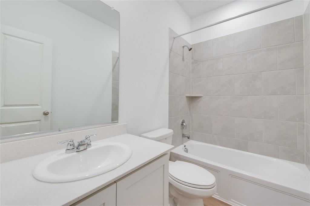 1108 Rumble Drive Fate, TX 75087 - Photo 12 of 12 a bathroom with a sink a toilet and shower