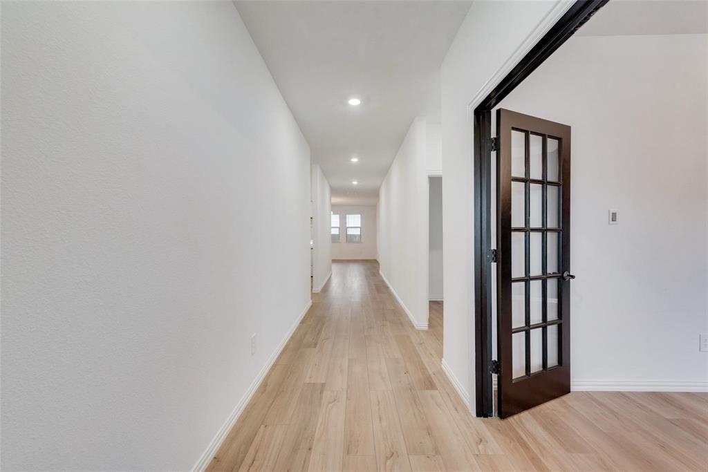1108 Rumble Drive Fate, TX 75087 - Photo 2 of 12 a view of a hallway with wooden floor and entryway
