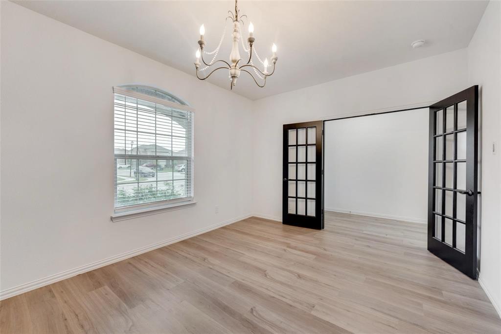 1108 Rumble Drive Fate, TX 75087 - Photo 4 of 12 a view of an empty room with wooden floor and a window