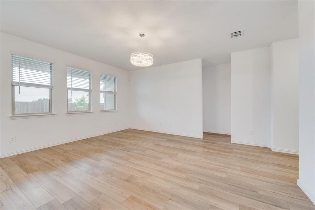 1108 Rumble Drive Fate, TX 75087 - Photo 7 of 12 a view of an empty room with wooden floor and a window