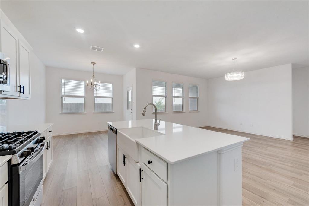 1108 Rumble Drive Fate, TX 75087 - Photo 10 of 12 a kitchen with sink microwave and stove