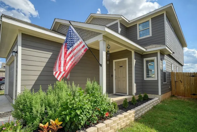 a front view of a house with a yard