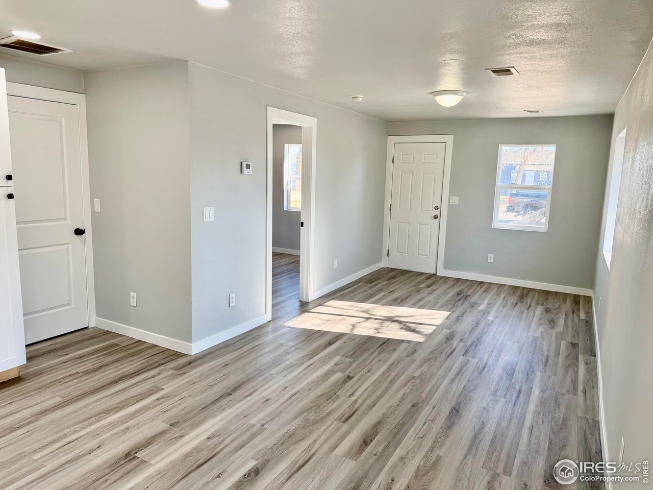 2015 5th Avenue, Unit A AND B Greeley, CO 80631 - Photo 11 of 15 an empty room with wooden floor and windows