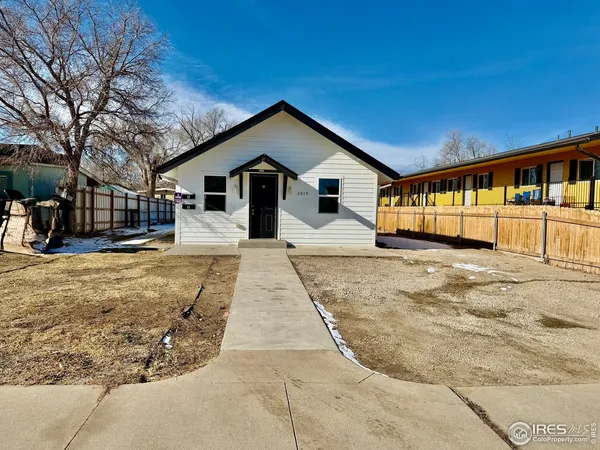 a view of a house with a yard covered in snow