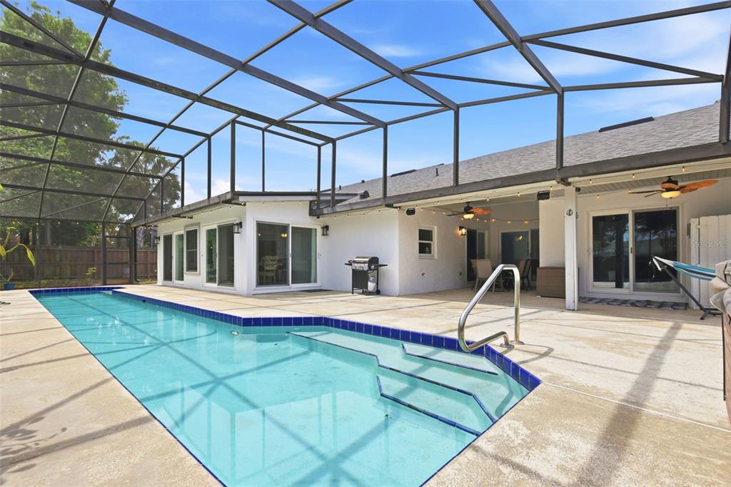 7432 Sparkling Lake Road Orlando, FL 32819 - Photo 35 of 54 a view of a swimming pool with a patio