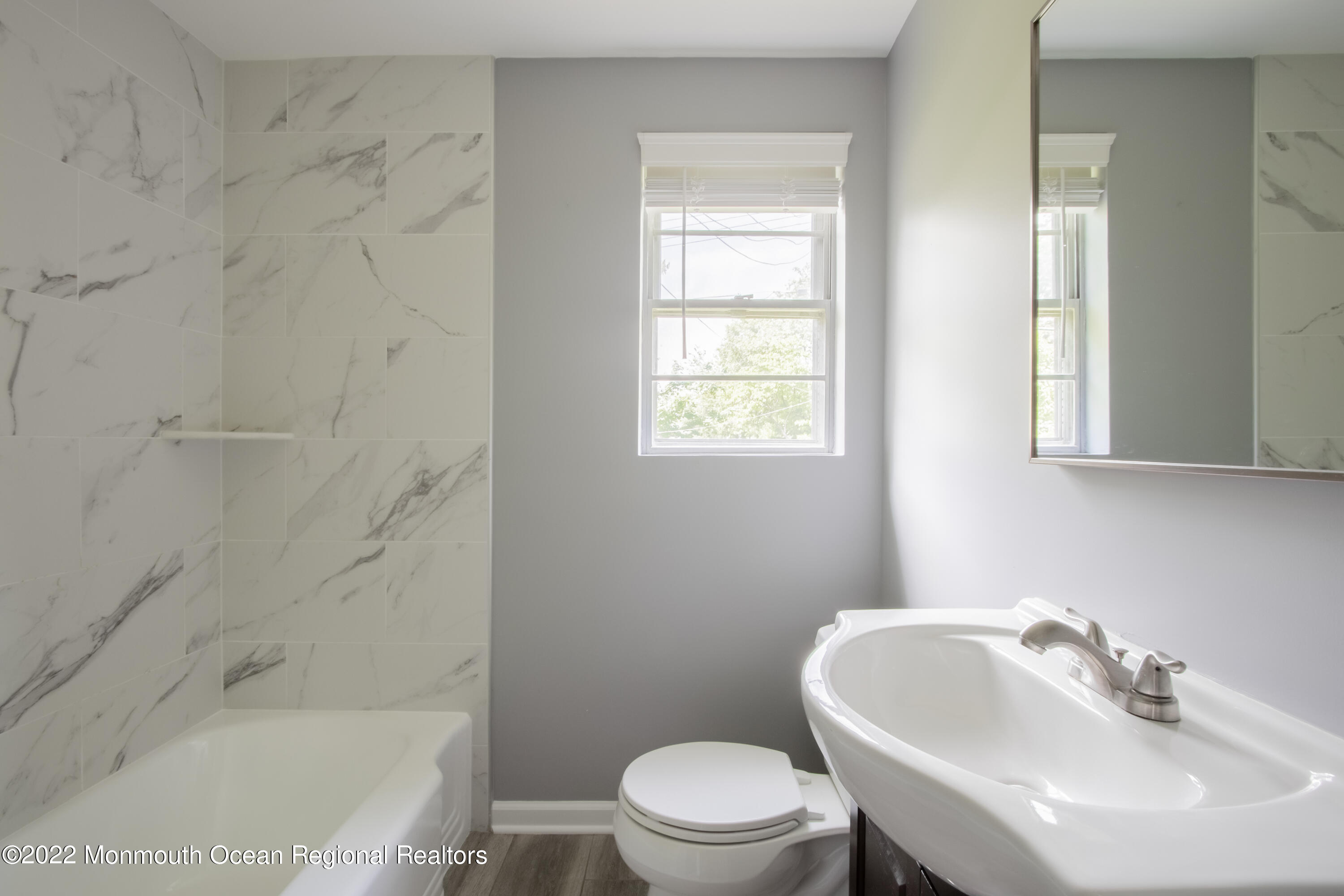 27 Manor Drive Red Bank, NJ 07701 - Photo 12 of 17 a bathroom with a sink a toilet and shower