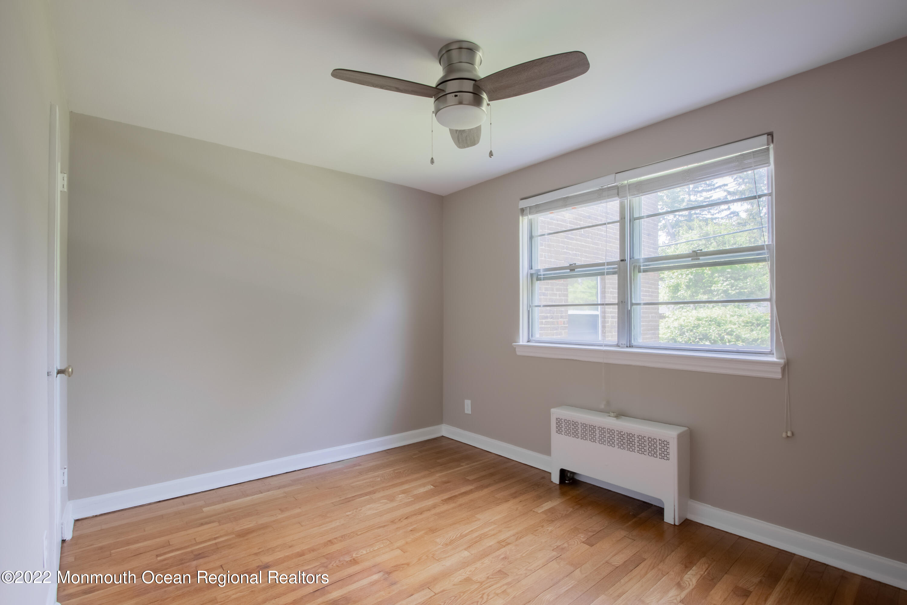 27 Manor Drive Red Bank, NJ 07701 - Photo 13 of 17 wooden floor in an empty room with a window