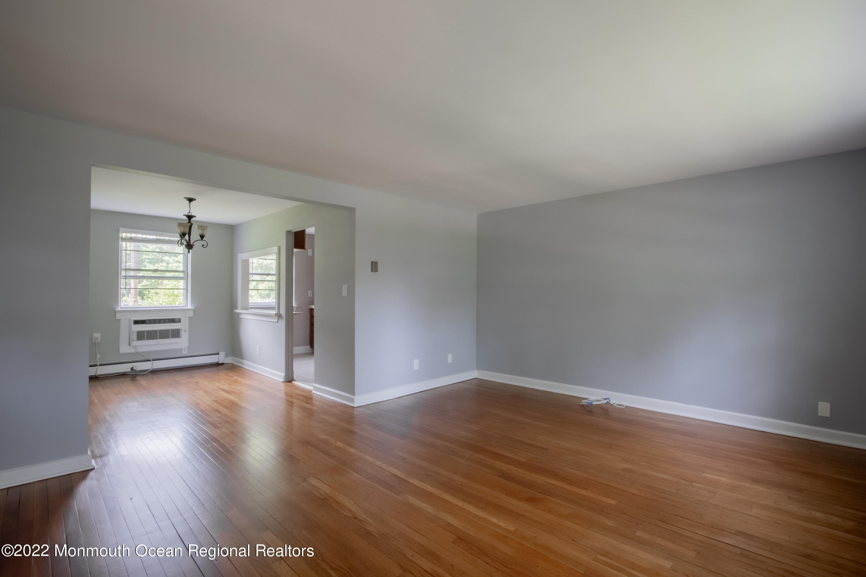 27 Manor Drive Red Bank, NJ 07701 - Photo 3 of 17 a view of an empty room with wooden floor and windows