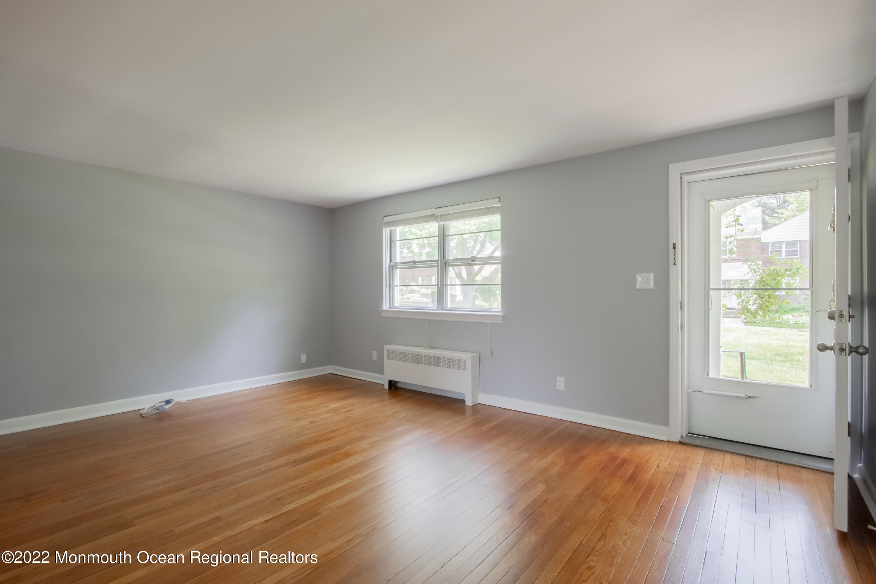 27 Manor Drive Red Bank, NJ 07701 - Photo 4 of 17 an empty room with wooden floor and windows