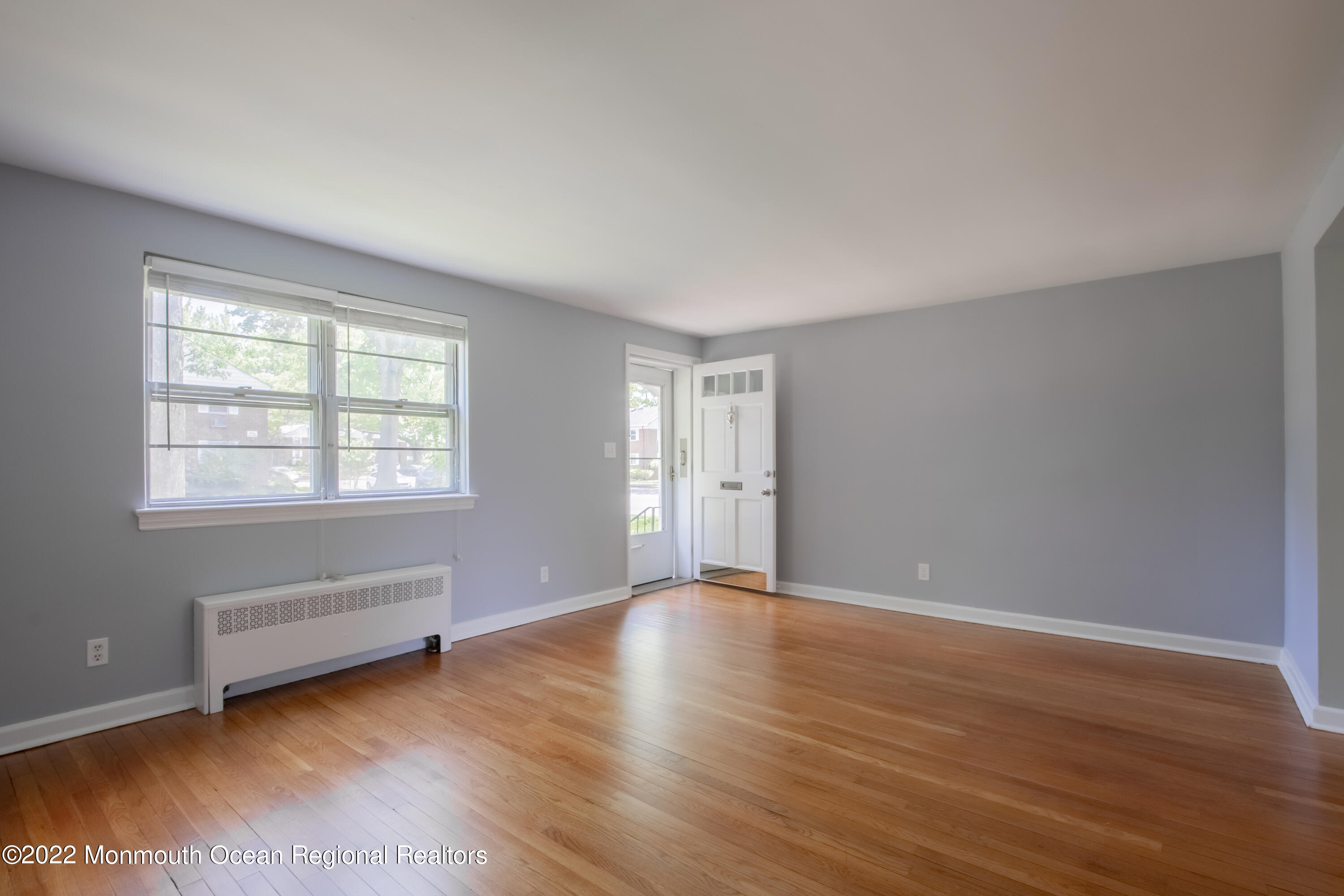 27 Manor Drive Red Bank, NJ 07701 - Photo 5 of 17 an empty room with wooden floor and windows