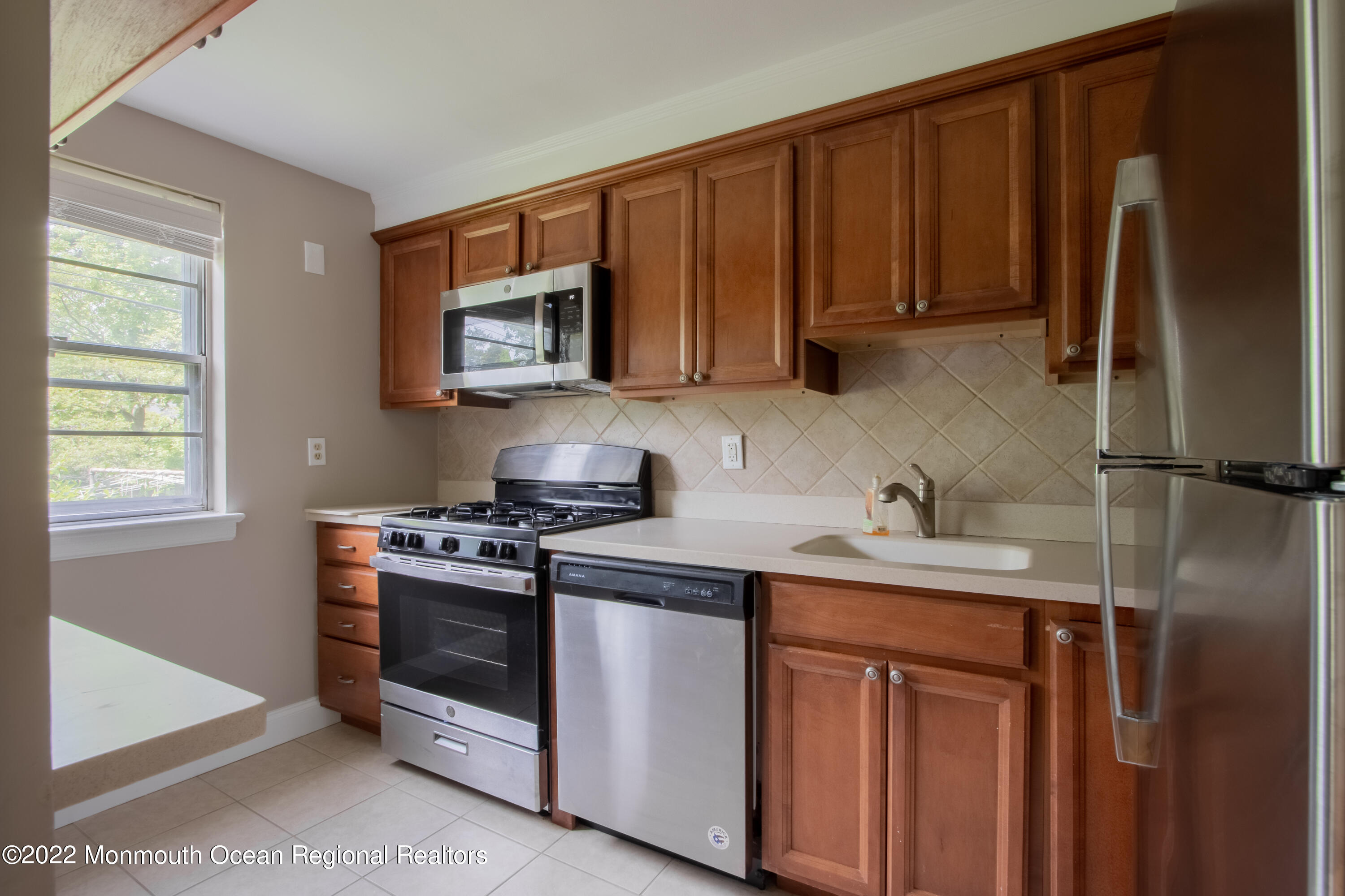 27 Manor Drive Red Bank, NJ 07701 - Photo 7 of 17 a kitchen with stainless steel appliances granite countertop a stove a refrigerator and a sink