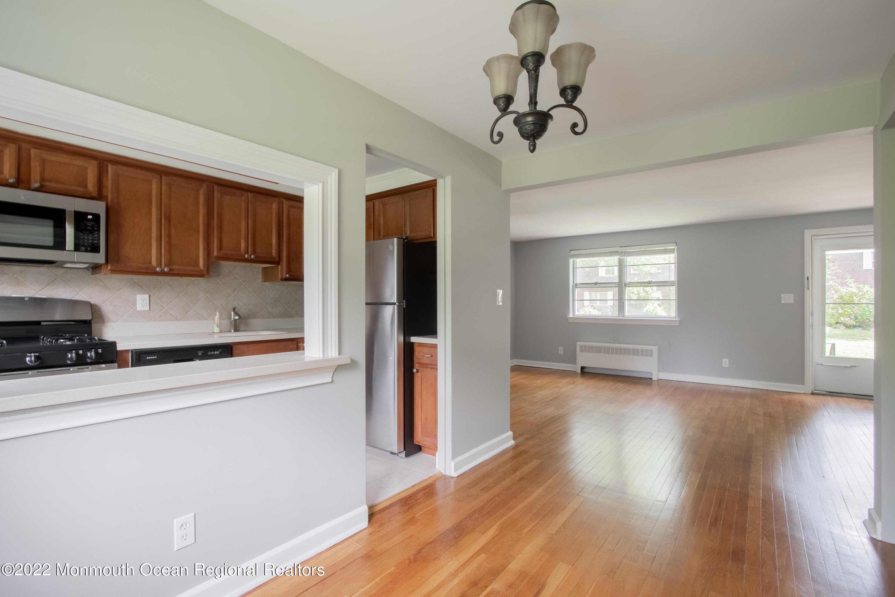 27 Manor Drive Red Bank, NJ 07701 - Photo 9 of 17 a kitchen with stainless steel appliances granite countertop a refrigerator a stove top oven a sink dishwasher and wooden floor