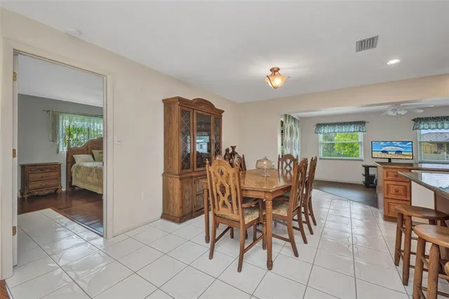 a view of a dining room with furniture and a kitchen