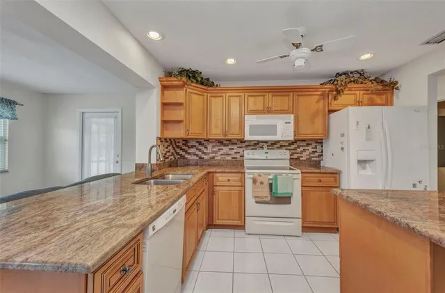 a kitchen with stainless steel appliances granite countertop a sink and cabinets