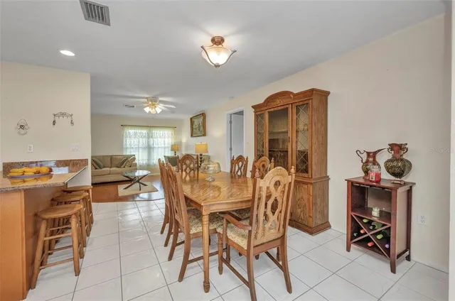 a view of a dining room with furniture and a chandelier fan