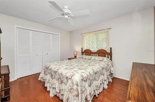 a bed sitting in a spacious bedroom next to a window