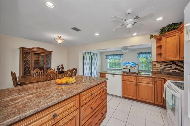 a kitchen with stainless steel appliances granite countertop a sink and cabinets