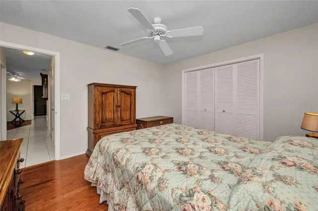 a bedroom with a large bed and a chandelier