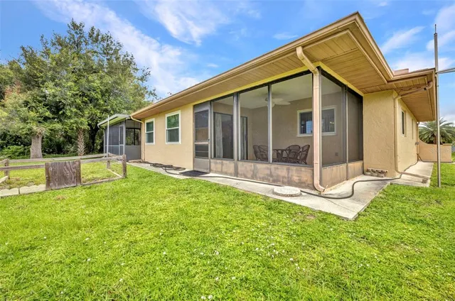 a view of a house with backyard and porch