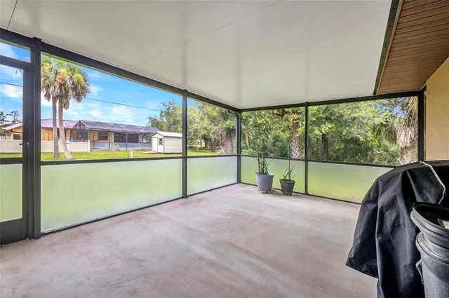 a view of an empty room with large windows