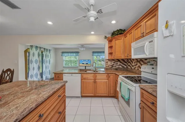 a kitchen with stainless steel appliances granite countertop a sink and cabinets