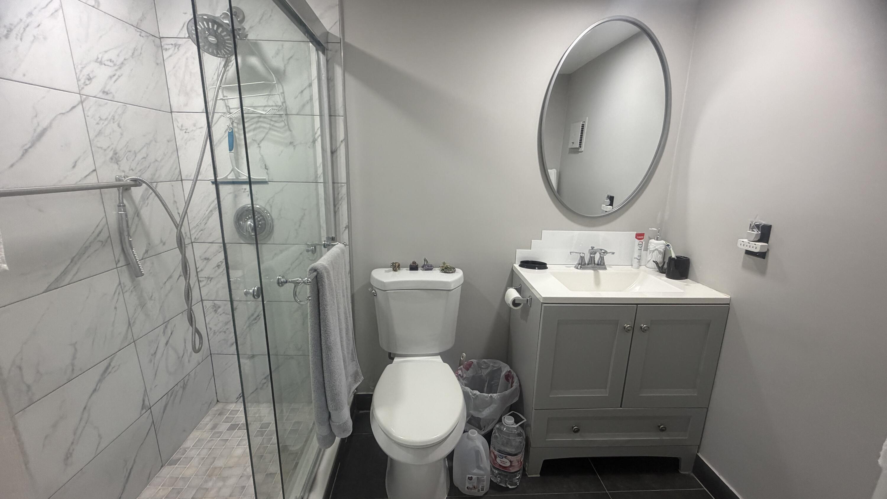 930 Normandy Trail Delray Beach, FL 33484 - Photo 10 of 34 a bathroom with a toilet sink and mirror