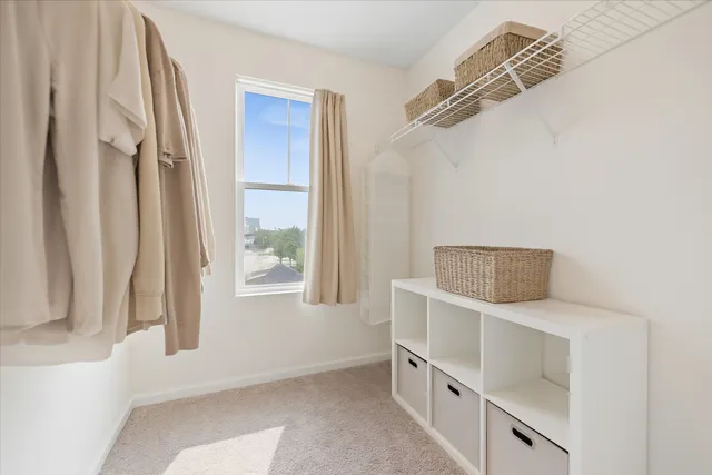 a large bed sitting in a bedroom next to a window and a larger closet