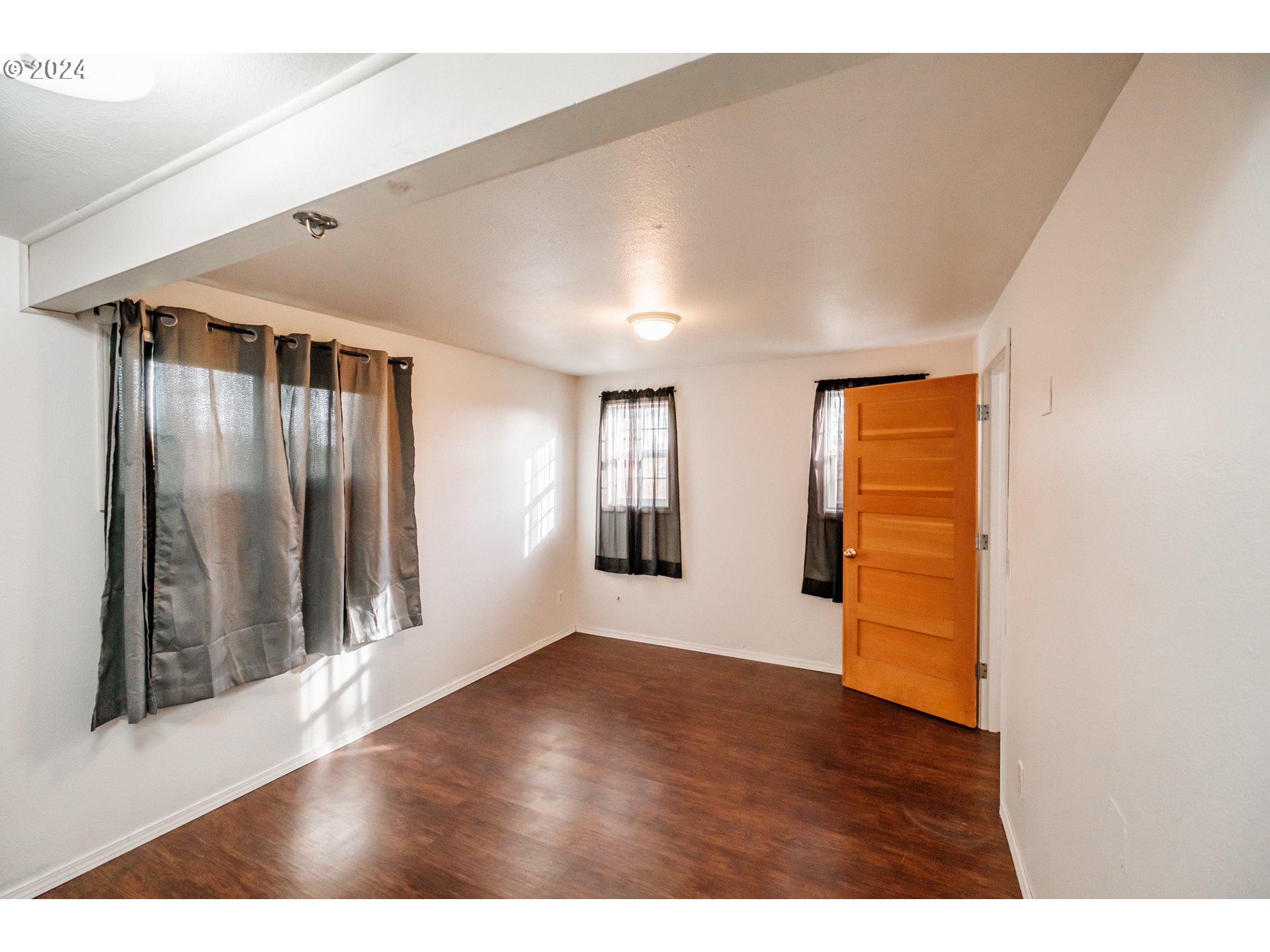 3725 Cordon Road Northeast Salem, OR 97305 - Photo 3 of 15 a view of an empty room with wooden floor