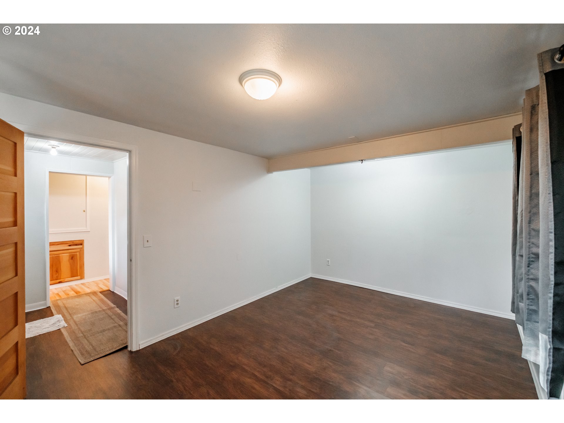 3725 Cordon Road Northeast Salem, OR 97305 - Photo 4 of 15 a view of an empty room with wooden floor and a window