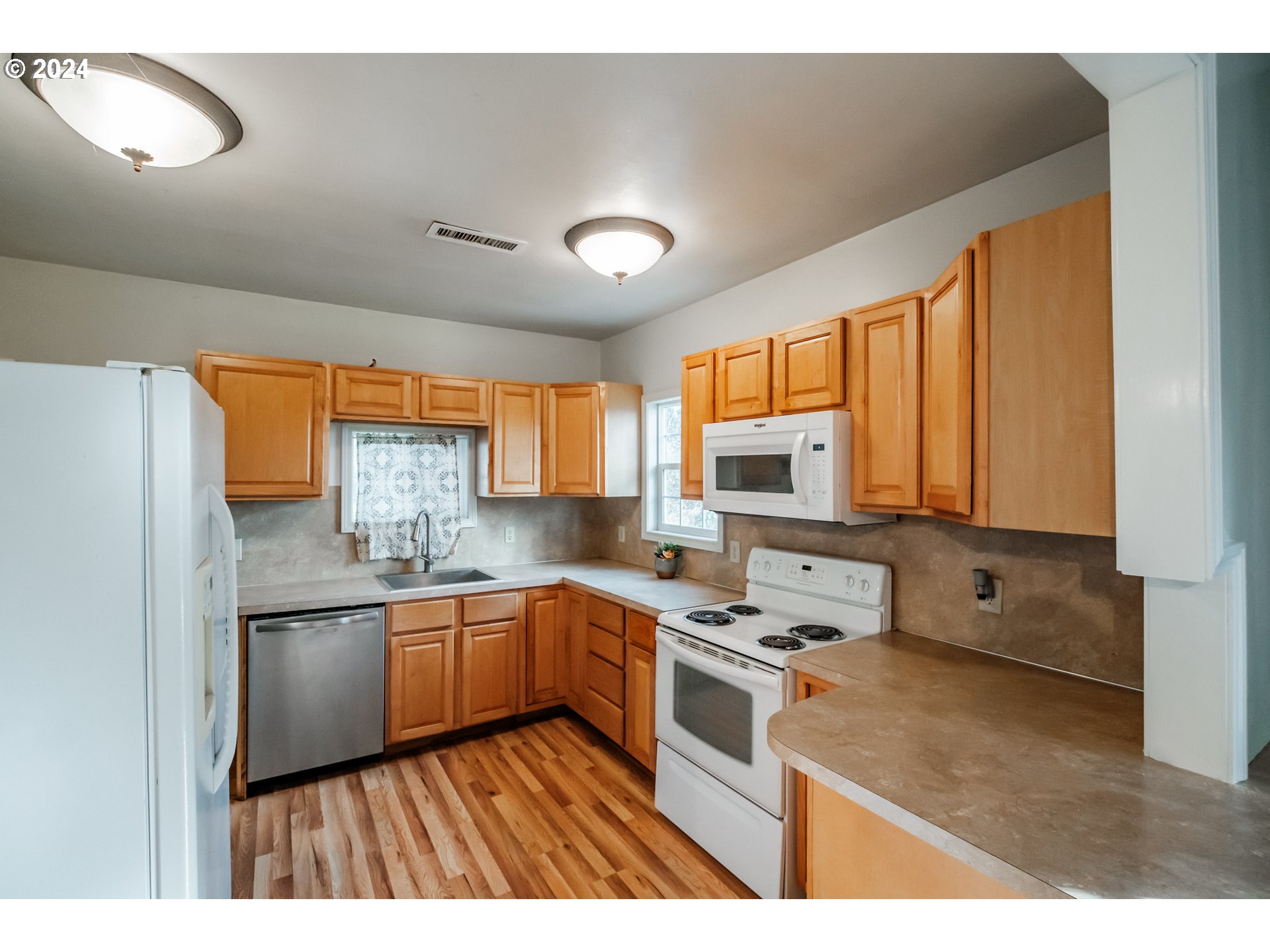 3725 Cordon Road Northeast Salem, OR 97305 - Photo 6 of 15 a kitchen with stainless steel appliances granite countertop a sink stove and refrigerator
