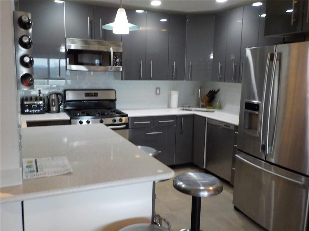 45 Edinburgh Drive Peekskill, NY 10566 - Photo 1 of 1 a kitchen with stainless steel appliances a refrigerator a sink a stove a microwave and wooden cabinets