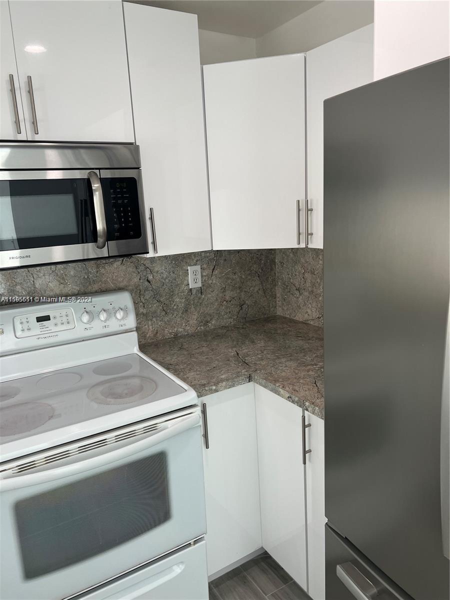 2050 Southwest 122nd Avenue, Unit 22 Miami, FL 33175 - Photo 11 of 24 a close view of stove and microwave