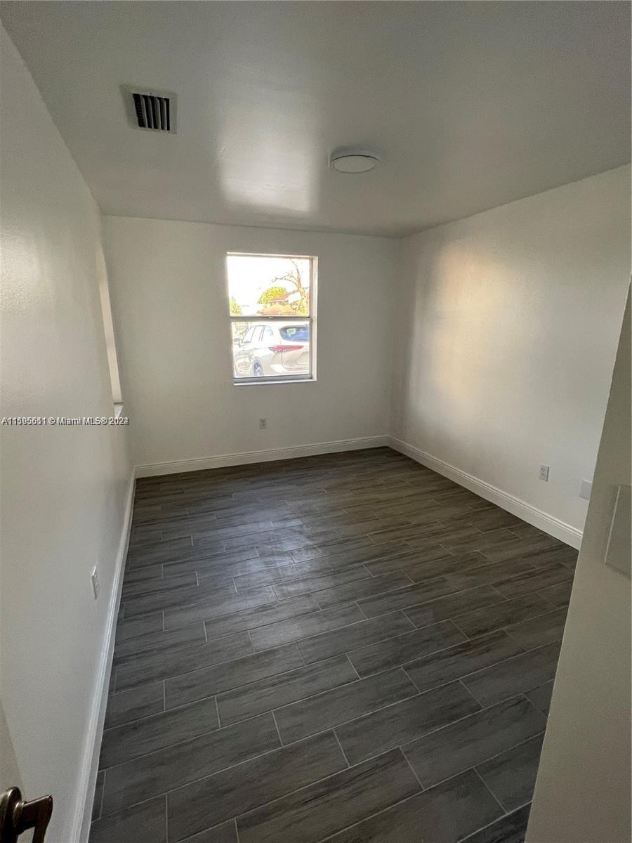 2050 Southwest 122nd Avenue, Unit 22 Miami, FL 33175 - Photo 12 of 24 an empty room with wooden floor and windows