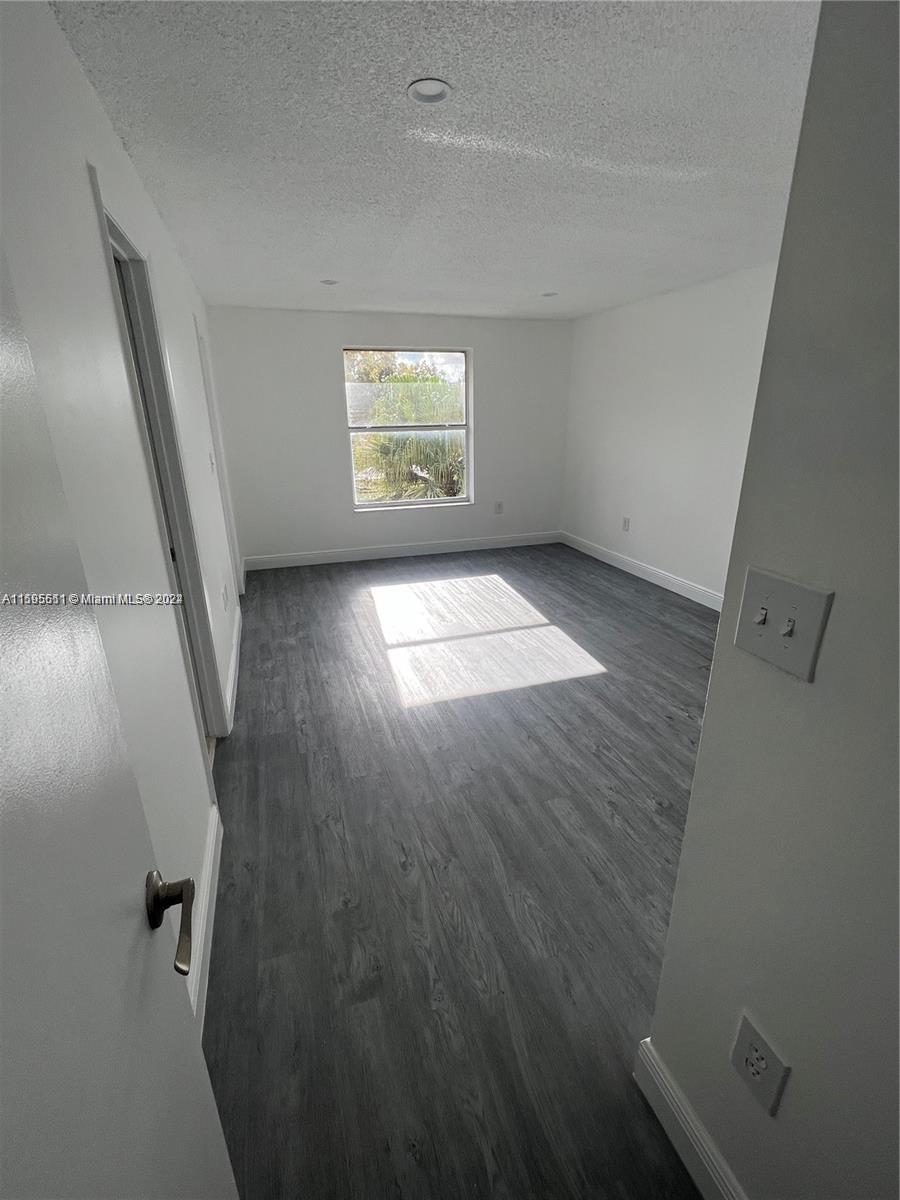 2050 Southwest 122nd Avenue, Unit 22 Miami, FL 33175 - Photo 19 of 24 wooden floor in an empty room with a window