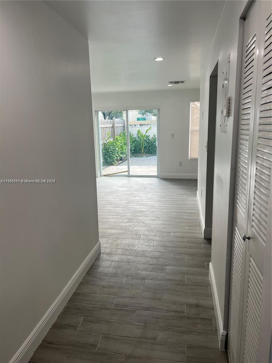 2050 Southwest 122nd Avenue, Unit 22 Miami, FL 33175 - Photo 2 of 24 a view of a room with wooden floor and a window
