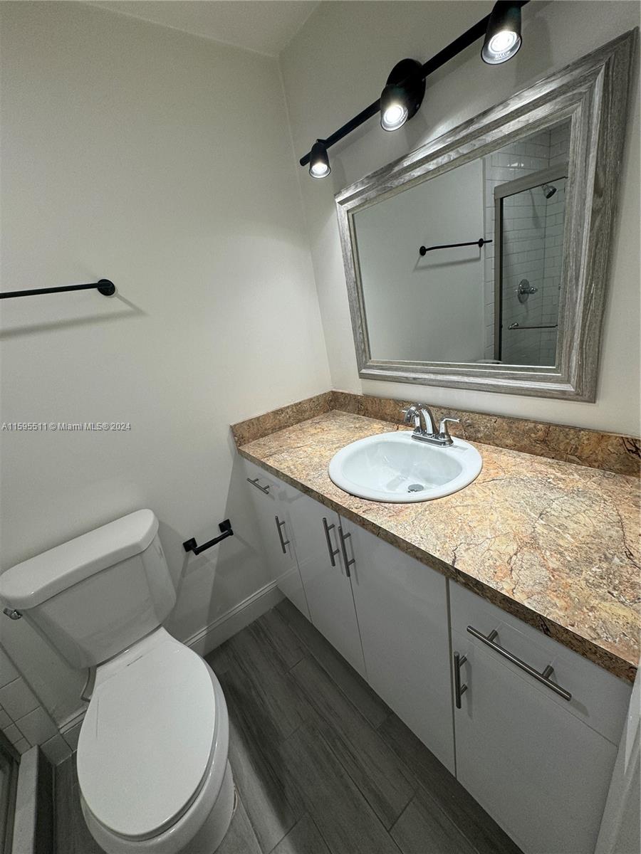 2050 Southwest 122nd Avenue, Unit 22 Miami, FL 33175 - Photo 4 of 24 a bathroom with a granite countertop toilet sink and mirror