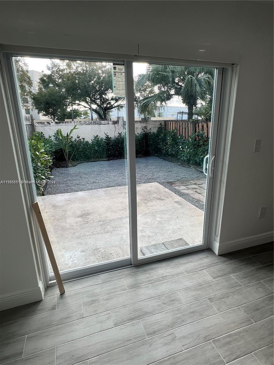 2050 Southwest 122nd Avenue, Unit 22 Miami, FL 33175 - Photo 6 of 24 a view of a floor to ceiling window and wooden floor