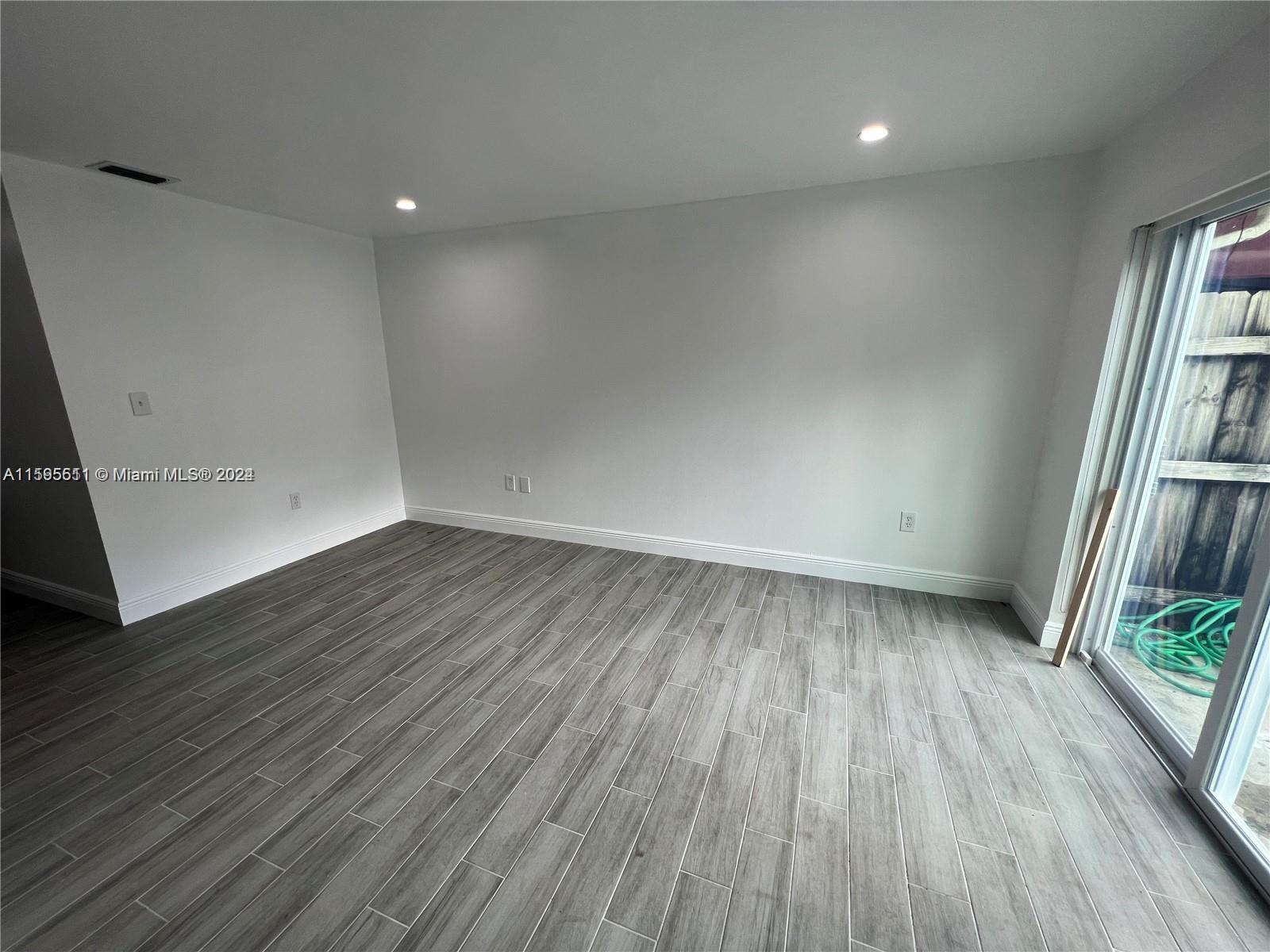 2050 Southwest 122nd Avenue, Unit 22 Miami, FL 33175 - Photo 8 of 24 an empty room with wooden floor and entrance