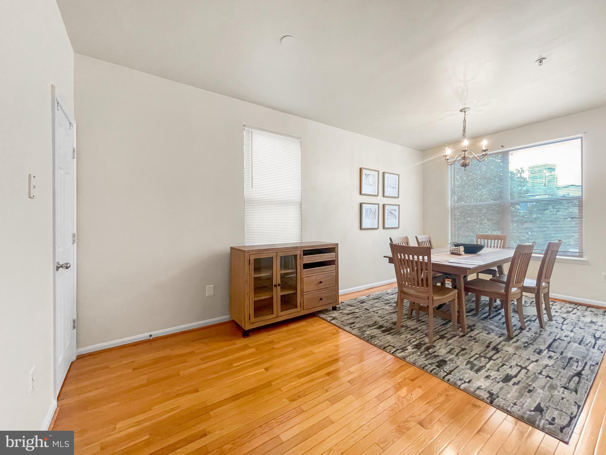 12 South Exeter Street, Unit 140 Baltimore, MD 21202 - Photo 14 of 30 a dining room with a table chairs and a dining table