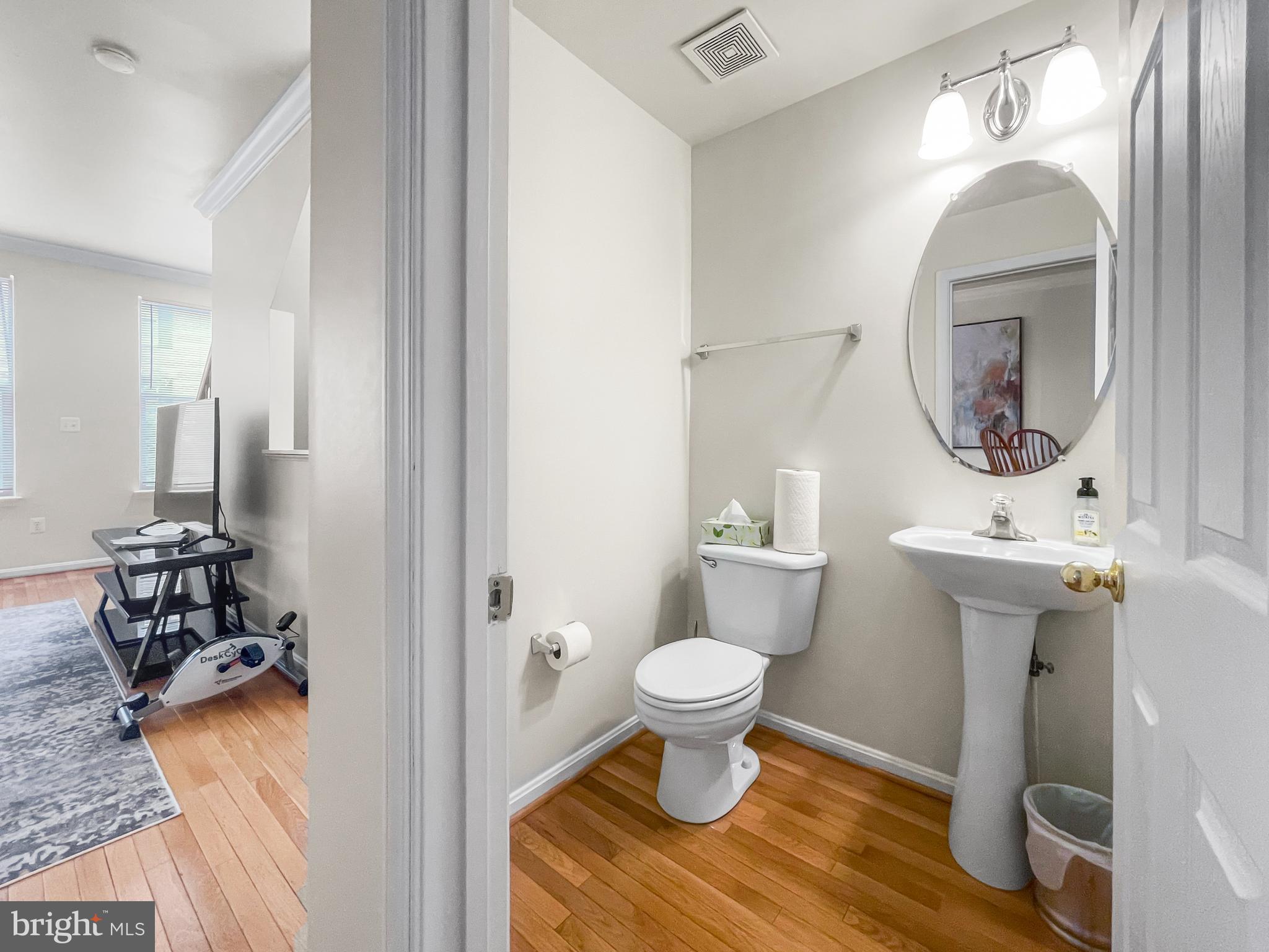 12 South Exeter Street, Unit 140 Baltimore, MD 21202 - Photo 15 of 30 a view of bathroom with a toilet sink and mirror