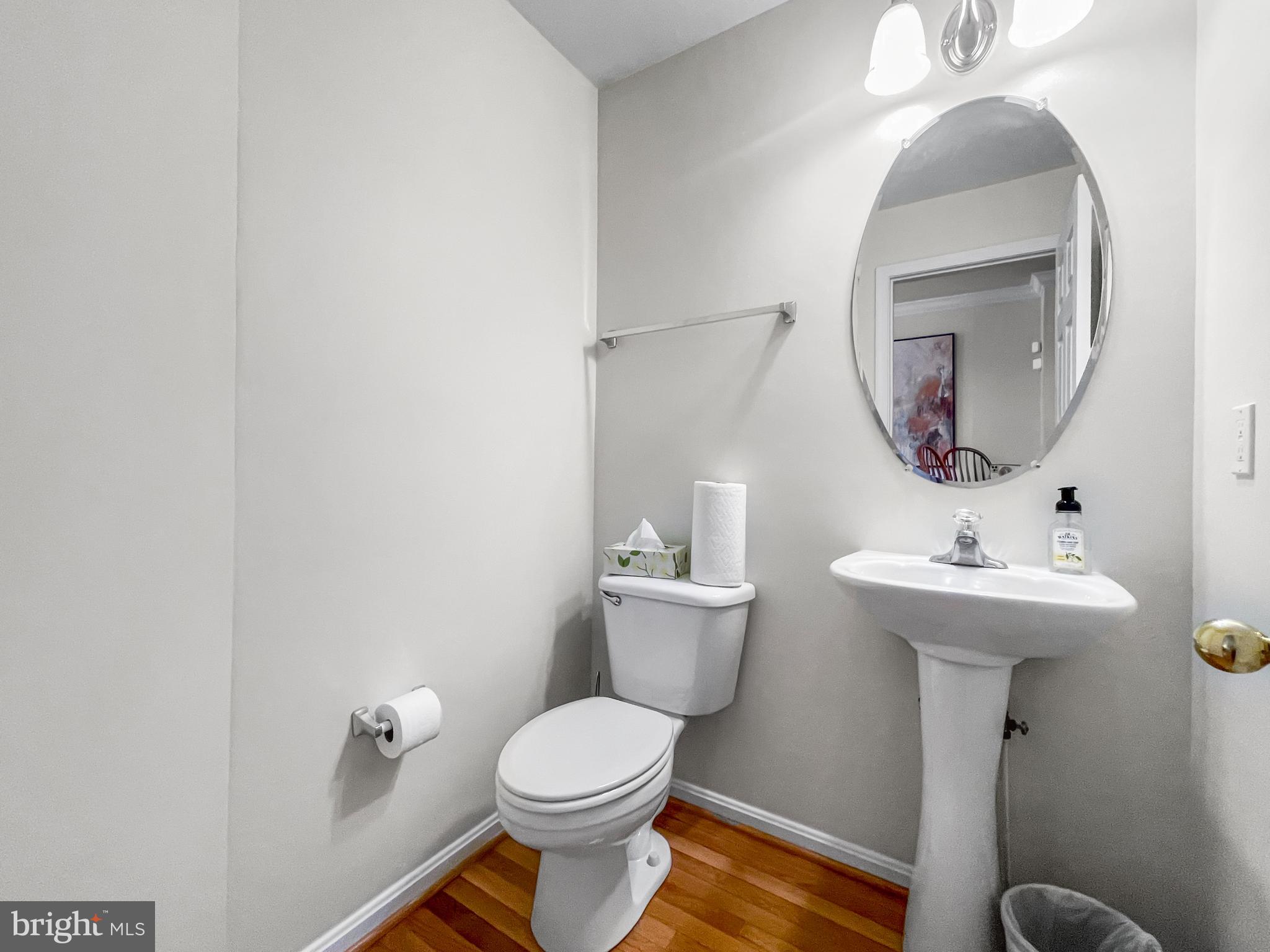 12 South Exeter Street, Unit 140 Baltimore, MD 21202 - Photo 16 of 30 a bathroom with a toilet a sink and mirror