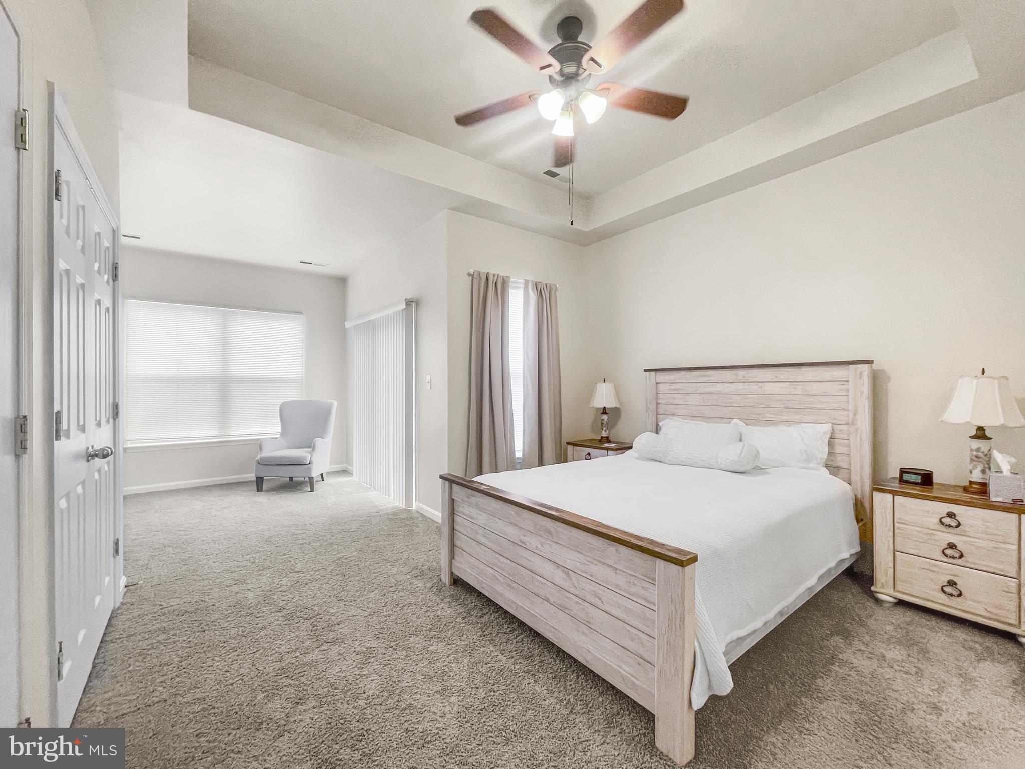 12 South Exeter Street, Unit 140 Baltimore, MD 21202 - Photo 17 of 30 a large bedroom with a bed and a chandelier