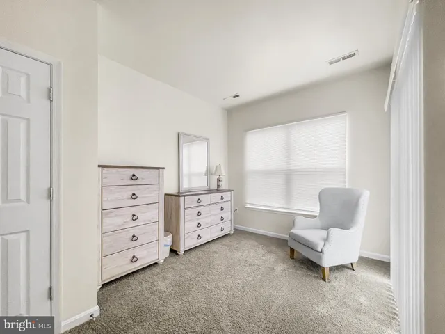 a living room with a bed and a chandelier